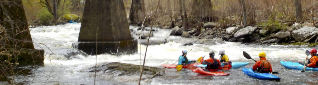 Pillars or teeth rapid on the Moodna. Low consequences thanks to the big pool. Main line is river left and above the paddlers heads in this picture. Sneak route is between the 2 pillars on left (river right) dropping over the far end of the sloping drop.